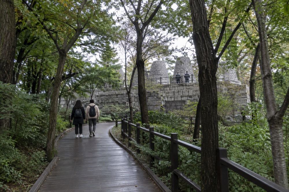 Wooden deck trail curving through forest on the lower slopes of Namsan