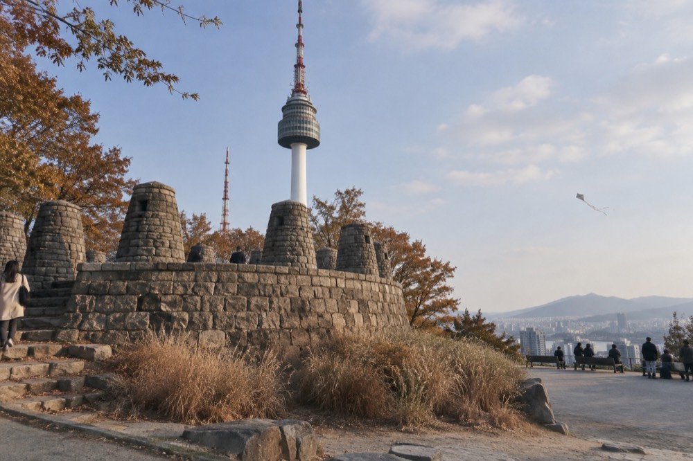 Open-air terrace near the tower base with the city spread out below and the tower rising overhead