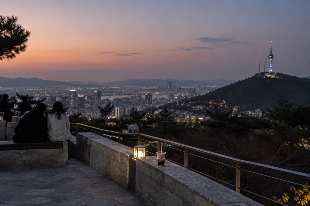 A city skyline at dusk seen from a hillside terrace