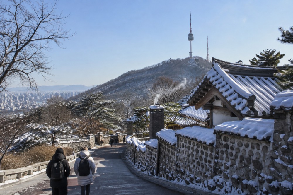 Frost-covered rooftops of Seoul under a clear blue winter sky