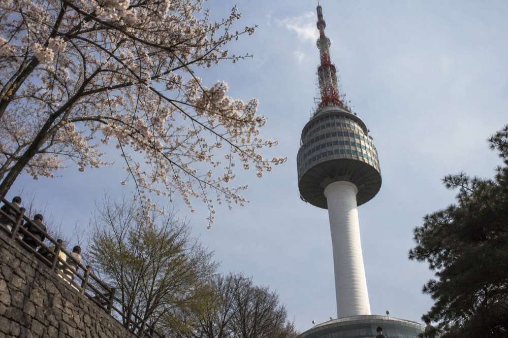 The upper section and mast of N Seoul Tower seen from the summit plaza