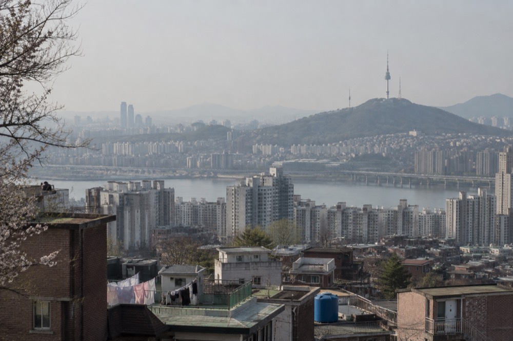 N Seoul Tower on its hill seen from across the Seoul cityscape