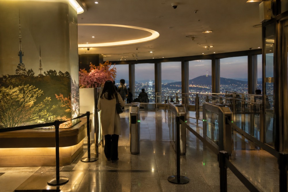 The observatory entrance and ticket area inside the tower, lit warmly for evening visitors