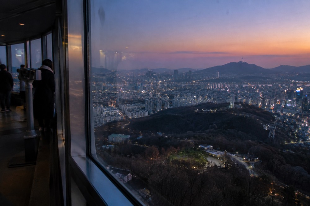 Seoul skyline seen through the tall windows of an observation deck