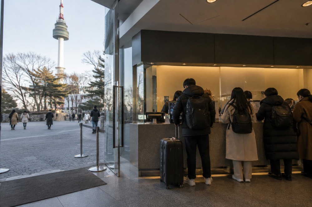 Ticket booth and information desk area at the tower base with the plaza beyond