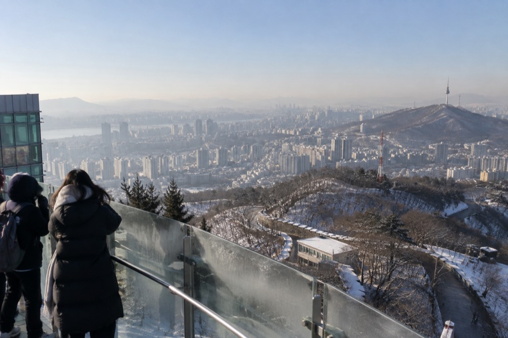 Frost-covered rooftops of Seoul seen from a high vantage point on a clear winter morning