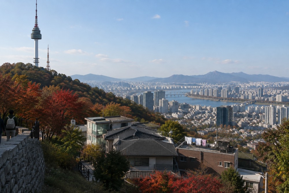 Wide view of Seoul rooftops and modern towers under a clear sky